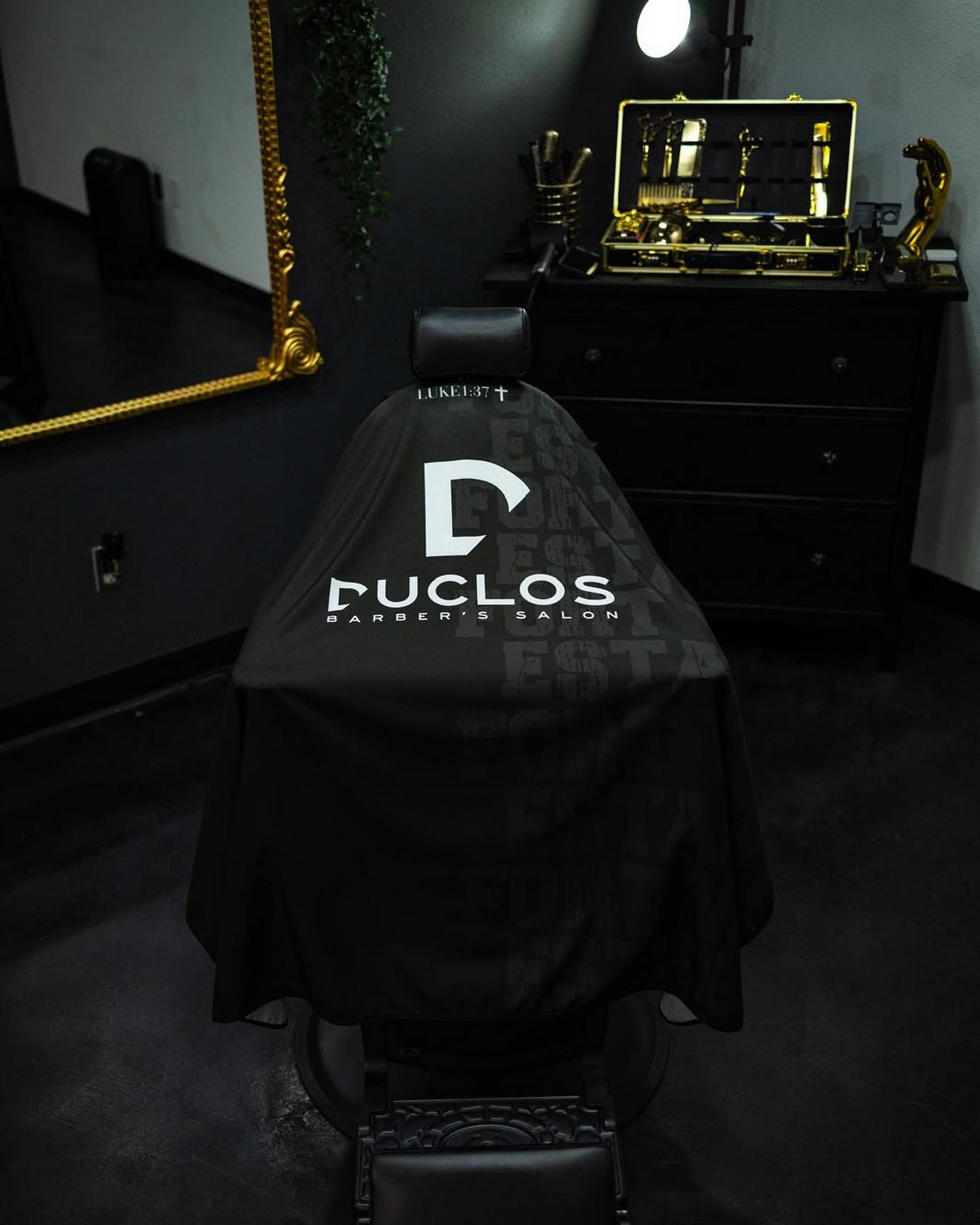 Duclos barber chair draped with a branded cape